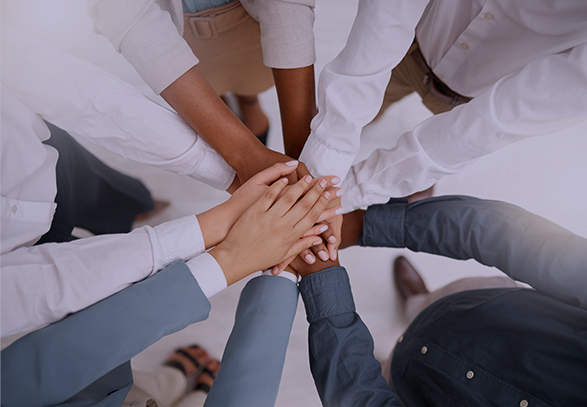 group of people standing in a circle with their hands in a circle
