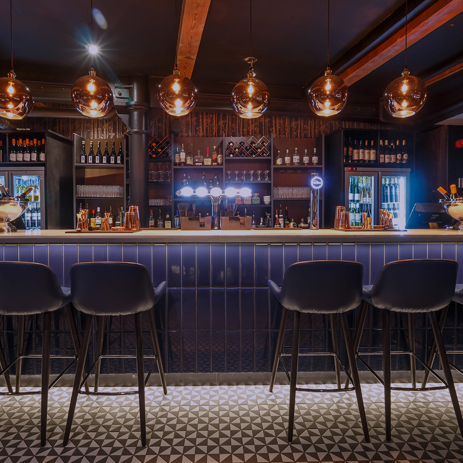 bar stools at a dimly lit bar